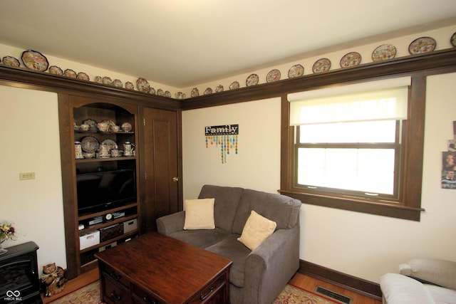 living room with light wood finished floors and visible vents