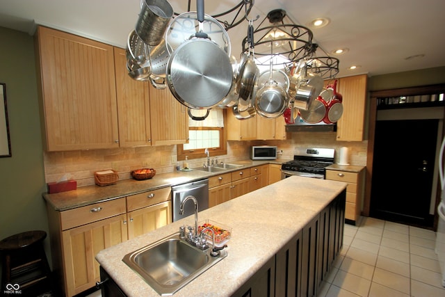kitchen with stainless steel appliances, light brown cabinets, and a sink