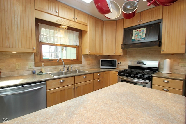 kitchen featuring a sink, stainless steel appliances, backsplash, light countertops, and range hood