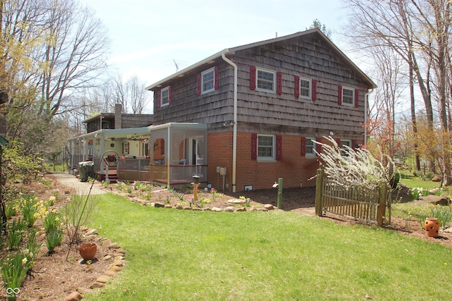 view of side of home with a yard and brick siding
