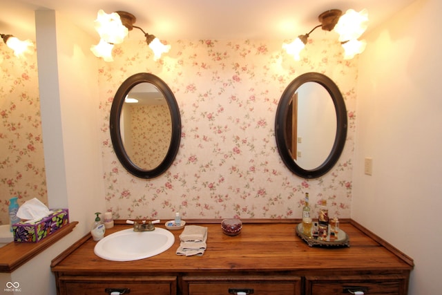 bathroom featuring wallpapered walls and vanity