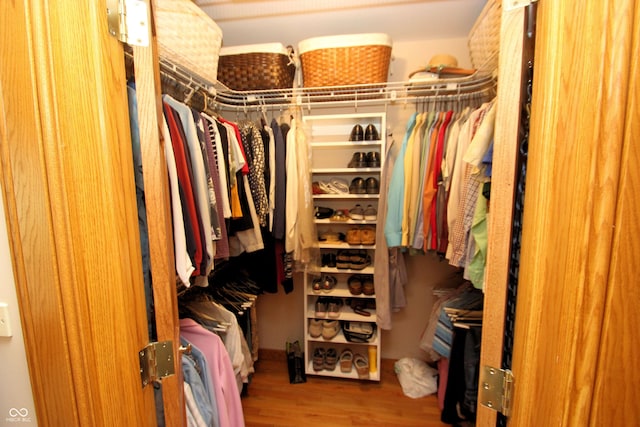 walk in closet featuring wood finished floors
