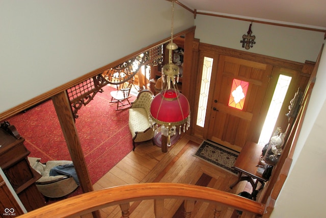 entryway featuring stairway, vaulted ceiling, and wood-type flooring