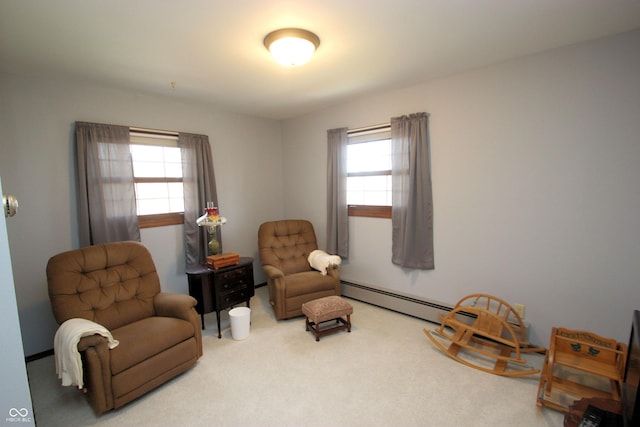 living area featuring carpet flooring, plenty of natural light, and a baseboard radiator