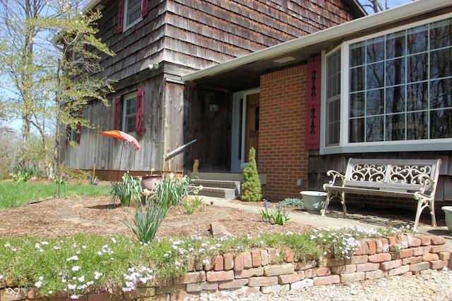 property entrance featuring brick siding