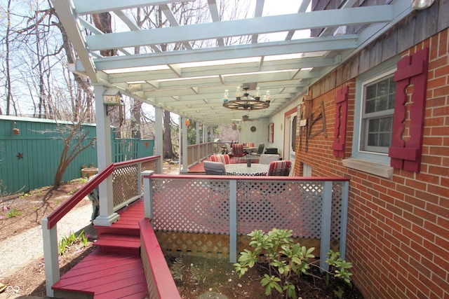 deck with a pergola, outdoor dining area, ceiling fan, and fence