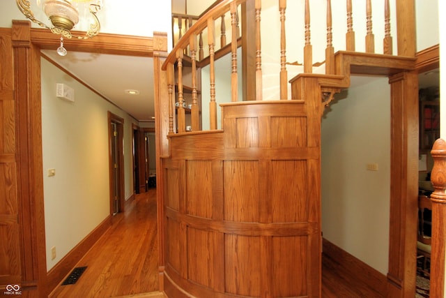 interior space with wood finished floors, visible vents, recessed lighting, crown molding, and baseboards