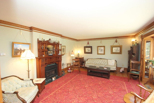 living room featuring a fireplace, crown molding, baseboards, and wood finished floors