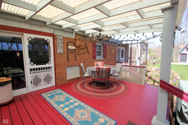 wooden terrace with a pergola and outdoor dining space