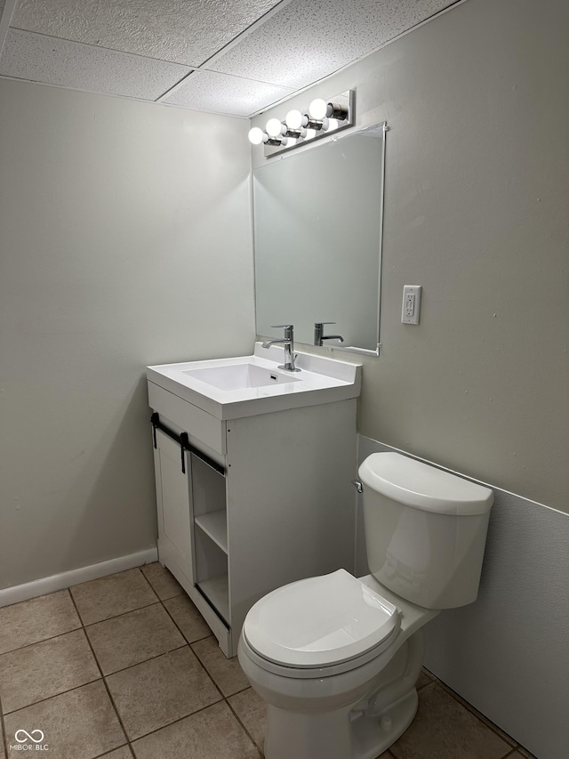 bathroom featuring toilet, vanity, and tile patterned floors