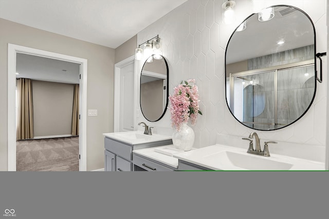 132 Oakhurst Way, Westfield, IN 46074 - bathroom featuring double vanity, a tile shower, and a sink