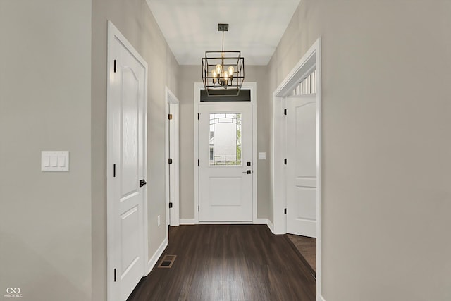 132 Oakhurst Way, Westfield, IN 46074 - entryway with an inviting chandelier, dark wood-style flooring, baseboards, and visible vents