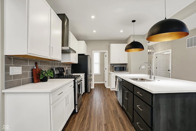 132 Oakhurst Way, Westfield, IN 46074 - kitchen with wall chimney range hood, white cabinets, appliances with stainless steel finishes, a sink, and dark wood-type flooring