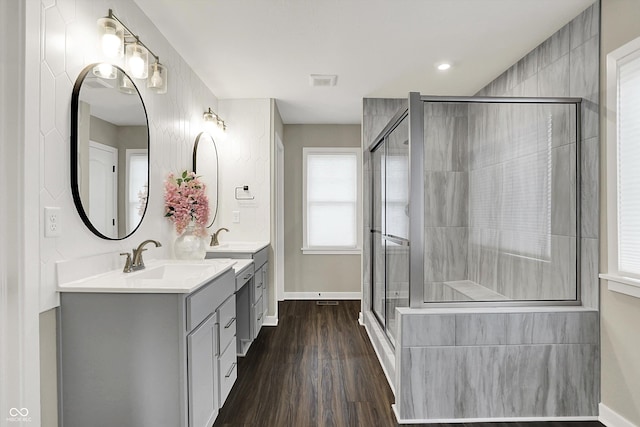 132 Oakhurst Way, Westfield, IN 46074 - bathroom featuring double vanity, baseboards, wood finished floors, and a stall shower