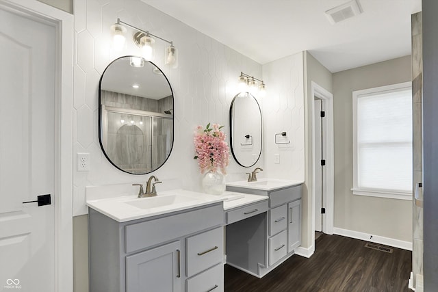 132 Oakhurst Way, Westfield, IN 46074 - full bath with visible vents, two vanities, a sink, and wood finished floors
