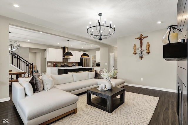 132 Oakhurst Way, Westfield, IN 46074 - living area with baseboards, dark wood-style floors, stairs, and a chandelier