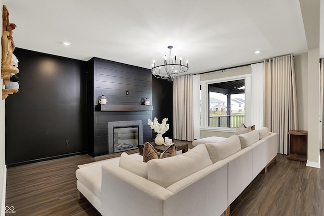 132 Oakhurst Way, Westfield, IN 46074 - living room with baseboards, an inviting chandelier, a large fireplace, and dark wood finished floors