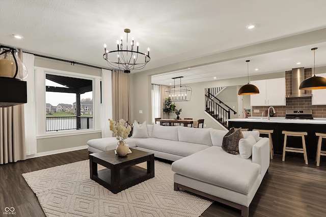 132 Oakhurst Way, Westfield, IN 46074 - living room with dark wood-style flooring, a chandelier, recessed lighting, baseboards, and stairway