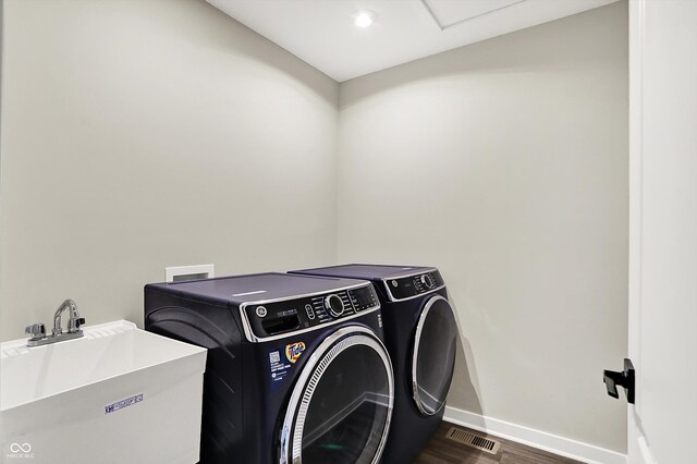 132 Oakhurst Way, Westfield, IN 46074 - laundry room with laundry area, a sink, dark wood finished floors, baseboards, and washing machine and dryer