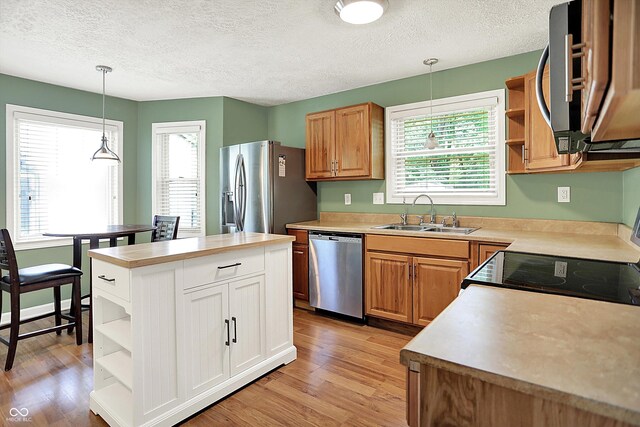 1697 Stacy Lynn Dr, Indianapolis, IN 46231 - kitchen featuring open shelves, a sink, stainless steel appliances, light wood-style flooring, and a textured ceiling