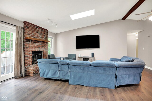 1697 Stacy Lynn Dr, Indianapolis, IN 46231 - living area with wood finished floors, rail lighting, a fireplace, and a ceiling fan
