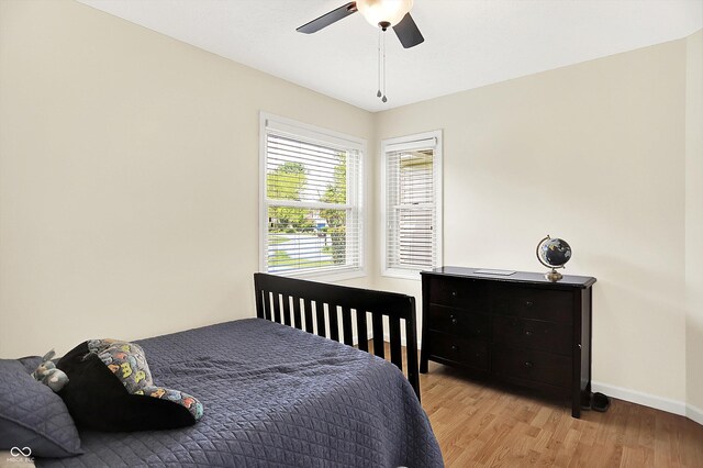 1697 Stacy Lynn Dr, Indianapolis, IN 46231 - bedroom with baseboards, light wood-style floors, and a ceiling fan