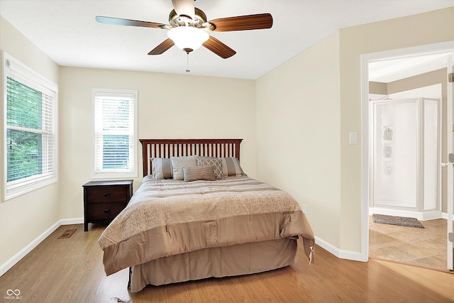 1697 Stacy Lynn Dr, Indianapolis, IN 46231 - bedroom featuring multiple windows, light wood finished floors, baseboards, and ceiling fan