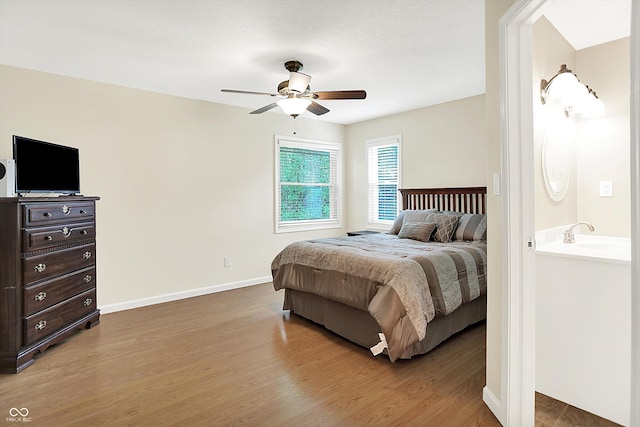 1697 Stacy Lynn Dr, Indianapolis, IN 46231 - bedroom with wood finished floors, baseboards, a sink, and a ceiling fan