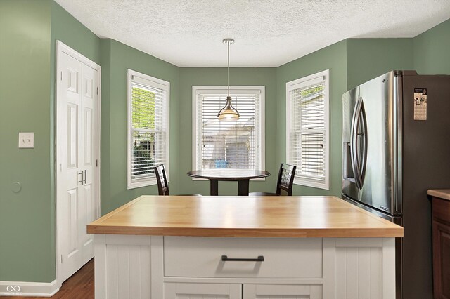 1697 Stacy Lynn Dr, Indianapolis, IN 46231 - kitchen with stainless steel refrigerator with ice dispenser, butcher block countertops, dark wood-type flooring, a textured ceiling, and hanging light fixtures