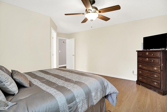 1697 Stacy Lynn Dr, Indianapolis, IN 46231 - bedroom with light wood-style floors, ceiling fan, and baseboards