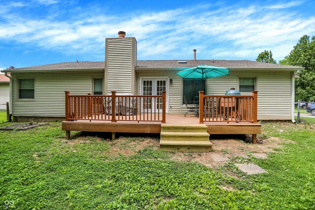 1697 Stacy Lynn Dr, Indianapolis, IN 46231 - rear view of property with a chimney, a wooden deck, and a lawn
