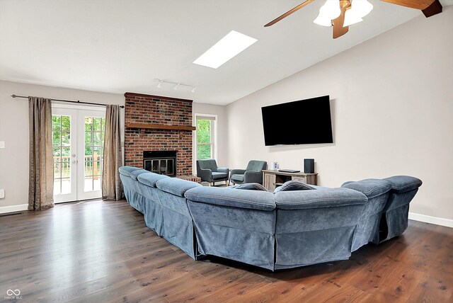 1697 Stacy Lynn Dr, Indianapolis, IN 46231 - living area with rail lighting, healthy amount of natural light, dark wood finished floors, and vaulted ceiling
