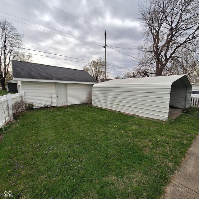 view of yard featuring an outdoor structure and fence