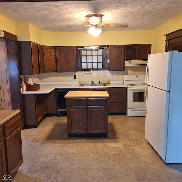 kitchen with ventilation hood, a textured ceiling, a sink, and white appliances