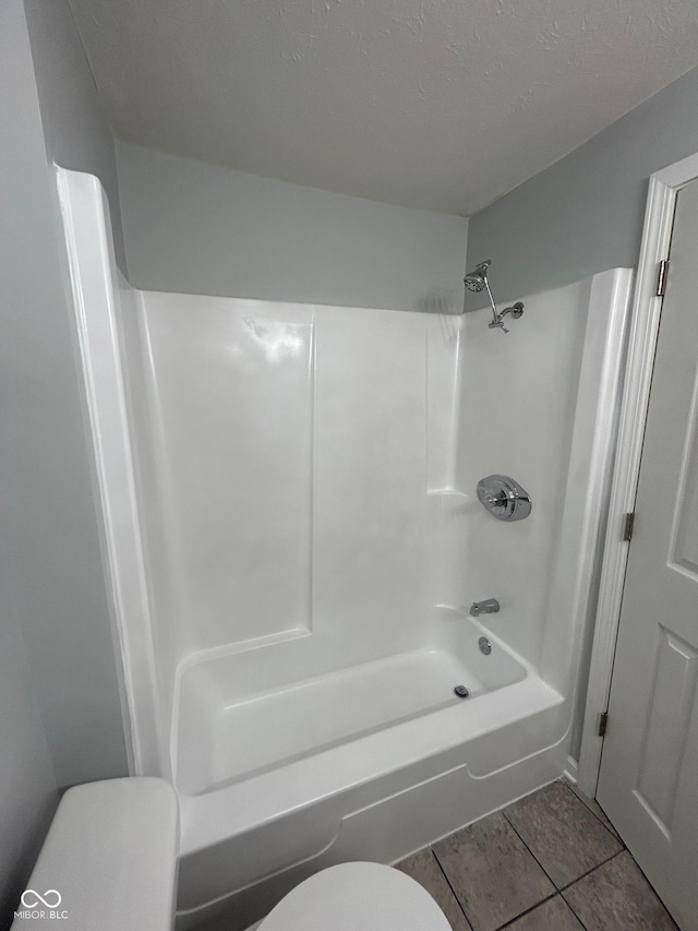 103 N Nebraska St, North Salem, IN 46165 - bathroom with tile patterned flooring, shower / bathtub combination, a textured ceiling, and toilet