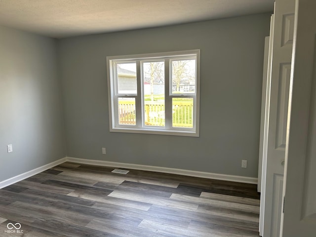 103 N Nebraska St, North Salem, IN 46165 - spare room with dark wood-style floors, baseboards, and visible vents