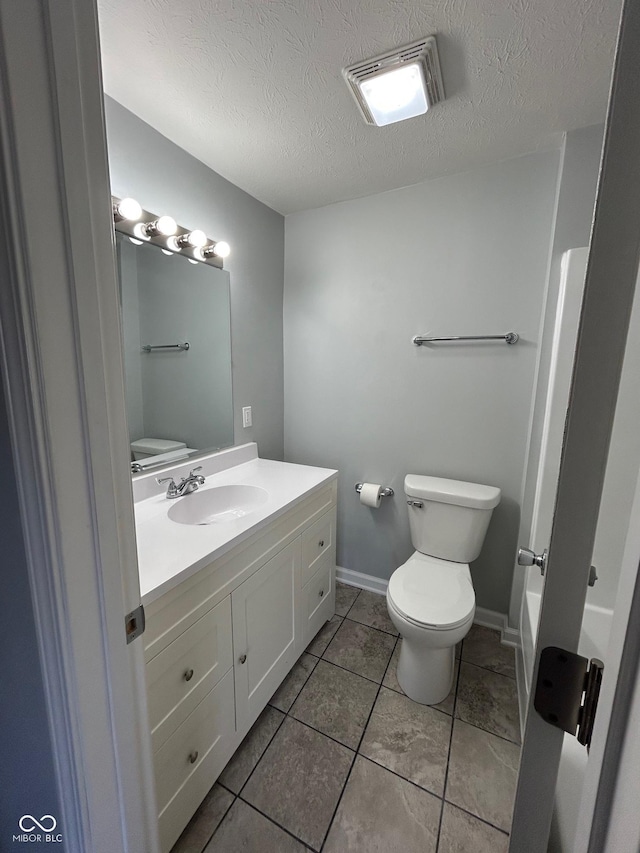 103 N Nebraska St, North Salem, IN 46165 - bathroom featuring vanity, baseboards, toilet, tile patterned flooring, and visible vents