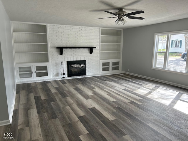 103 N Nebraska St, North Salem, IN 46165 - unfurnished living room featuring built in shelves, baseboards, and a textured ceiling