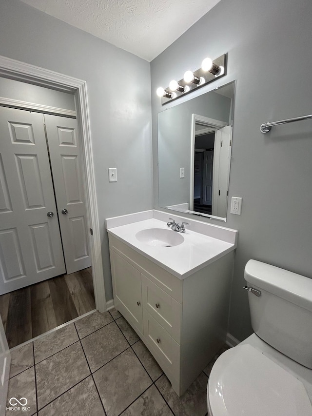 103 N Nebraska St, North Salem, IN 46165 - bathroom with a textured ceiling, toilet, vanity, and tile patterned floors