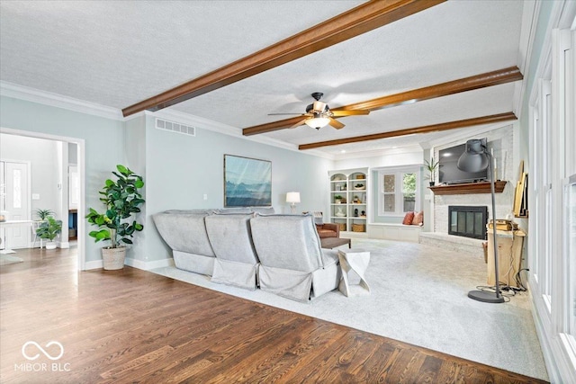 244 W Admiral Way S, Carmel, IN 46032 - living area with wood finished floors, a fireplace, a ceiling fan, beam ceiling, and ornamental molding