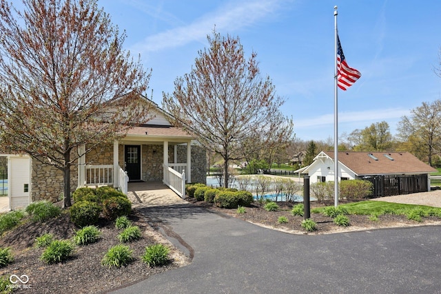 244 W Admiral Way S, Carmel, IN 46032 - view of front of house featuring stone siding, covered porch, and driveway