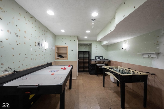 game room with recessed lighting, light floors, wallpapered walls, and a textured ceiling