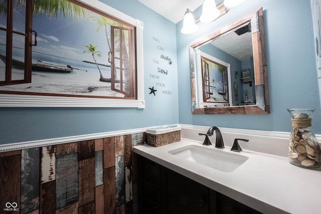 bathroom featuring a textured ceiling and vanity