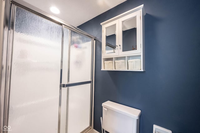 full bath with a stall shower and toilet