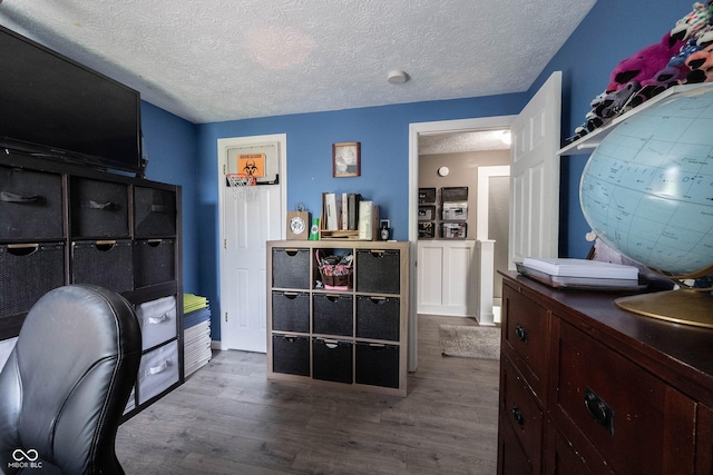 office area featuring baseboards, a textured ceiling, and wood finished floors