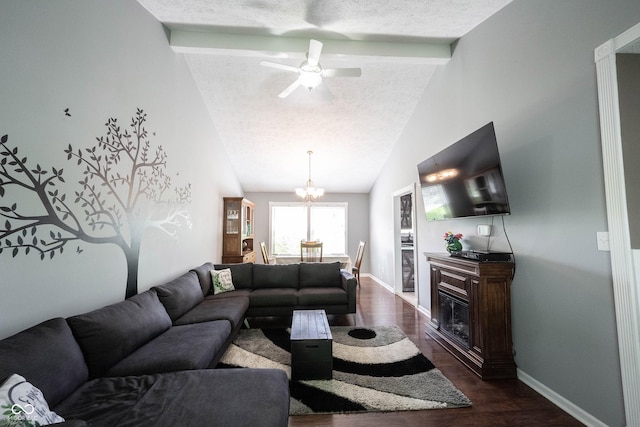 living room featuring a textured ceiling, baseboards, beamed ceiling, ceiling fan with notable chandelier, and dark wood-type flooring