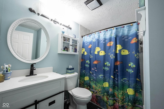 bathroom featuring vanity, a textured ceiling, a shower with shower curtain, and toilet
