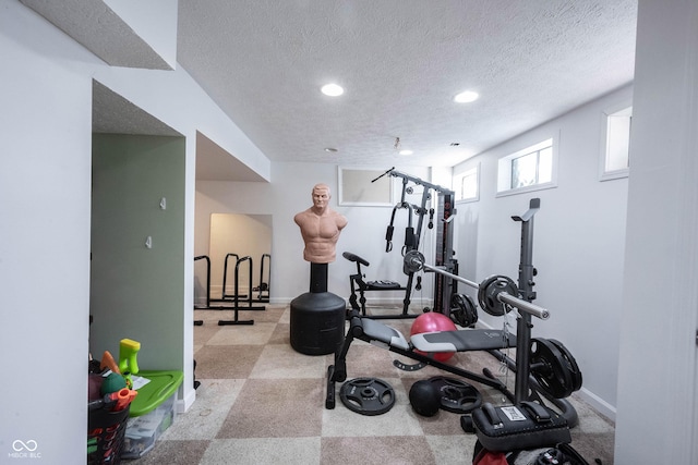 workout area with recessed lighting, a textured ceiling, and baseboards