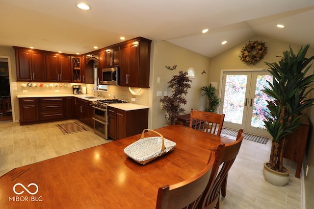 dining area with french doors, recessed lighting, and vaulted ceiling