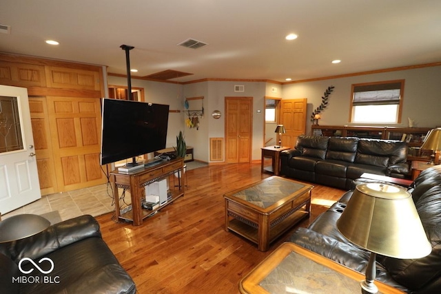 living area featuring visible vents and crown molding